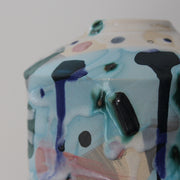 a close up detail of a textured pale blue and pink ceramic bottle by Dawn Hajittofi, English ceramicist 