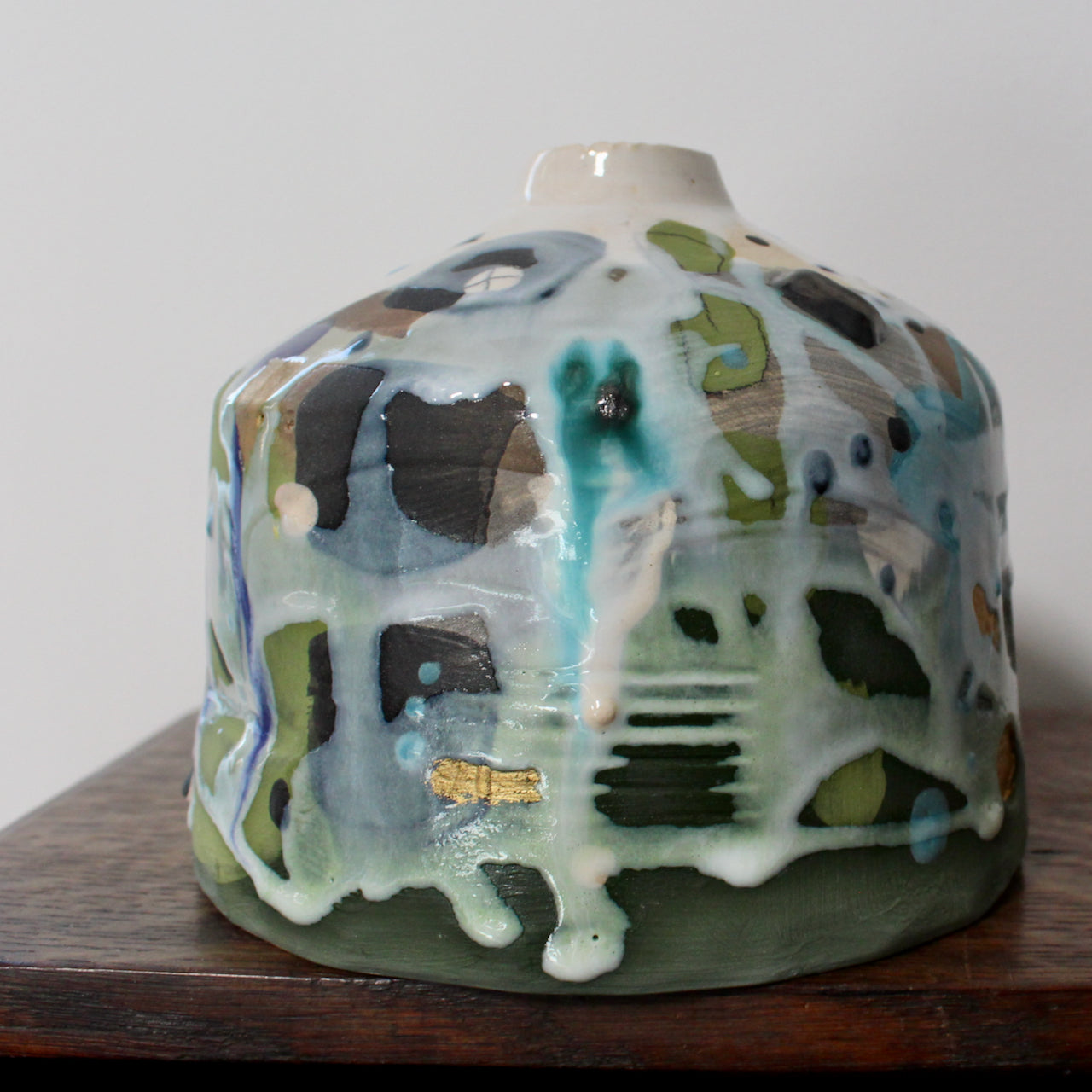 a short ceramic bottle in blue, green and white by Uk ceramicist Dawn Hajittofi.