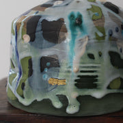 close up detail of short ceramic bottle in blue, green and white by Uk ceramicist Dawn Hajittofi