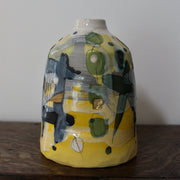 ceramic bottle in yellow, green and blue by British ceramicist Dawn Hajittofi.