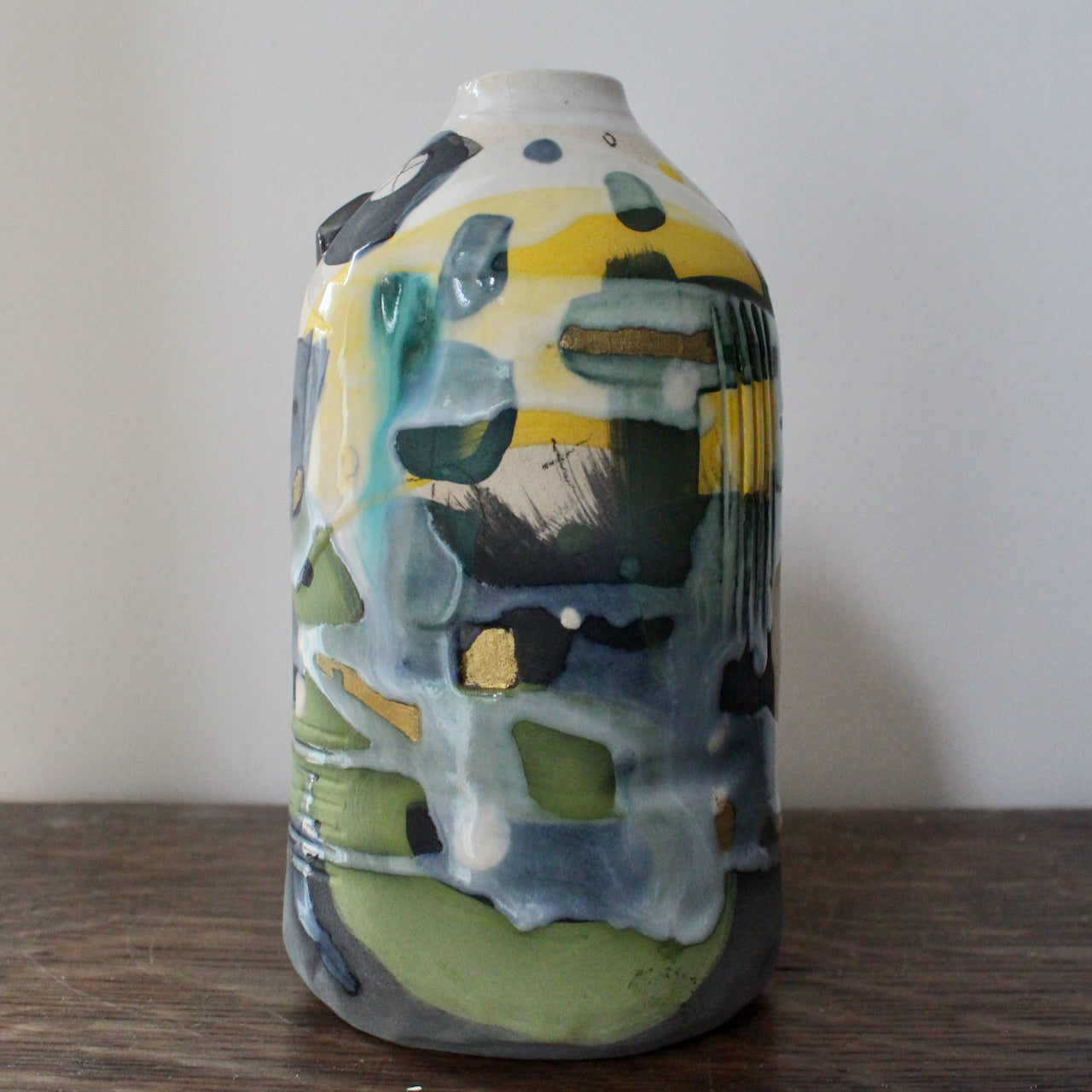 ceramic bottle in blue, green and yellow by ceramicist Dawn Hajittofi.