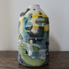 ceramic bottle in blue, green and yellow by ceramicist Dawn Hajittofi.