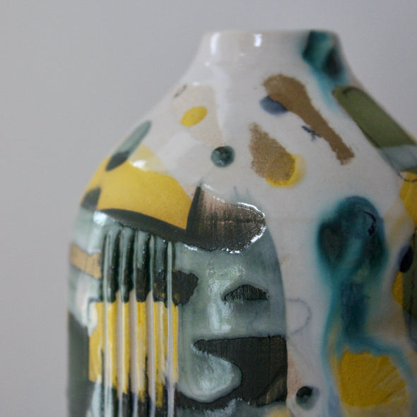 close up detail of a ceramic bottle in blue, green and yellow by Uk ceramicist Dawn Hajittofi