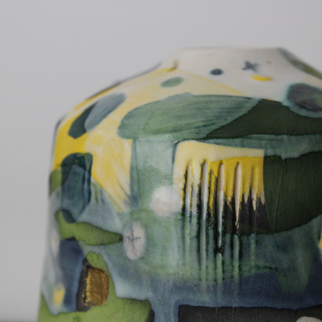 detail of small textured ceramic  bottle in yellow, grey and green by UK ceramicist Dawn Hajittofi