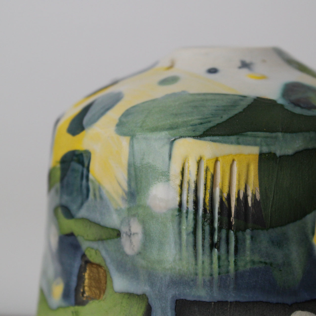 detail of small textured ceramic  bottle in yellow, grey and green by UK ceramicist Dawn Hajittofi