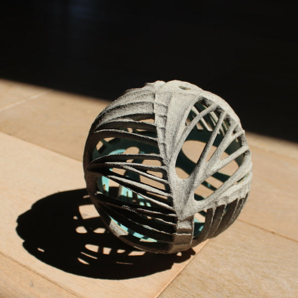 Michele Bianco carved and open round ceramic sculpture photographed in sunshine to show the shadow effect created.