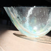 detail of glass vessel by UK glass artist Helen Eastham in pale green glass with white and turquoise details.