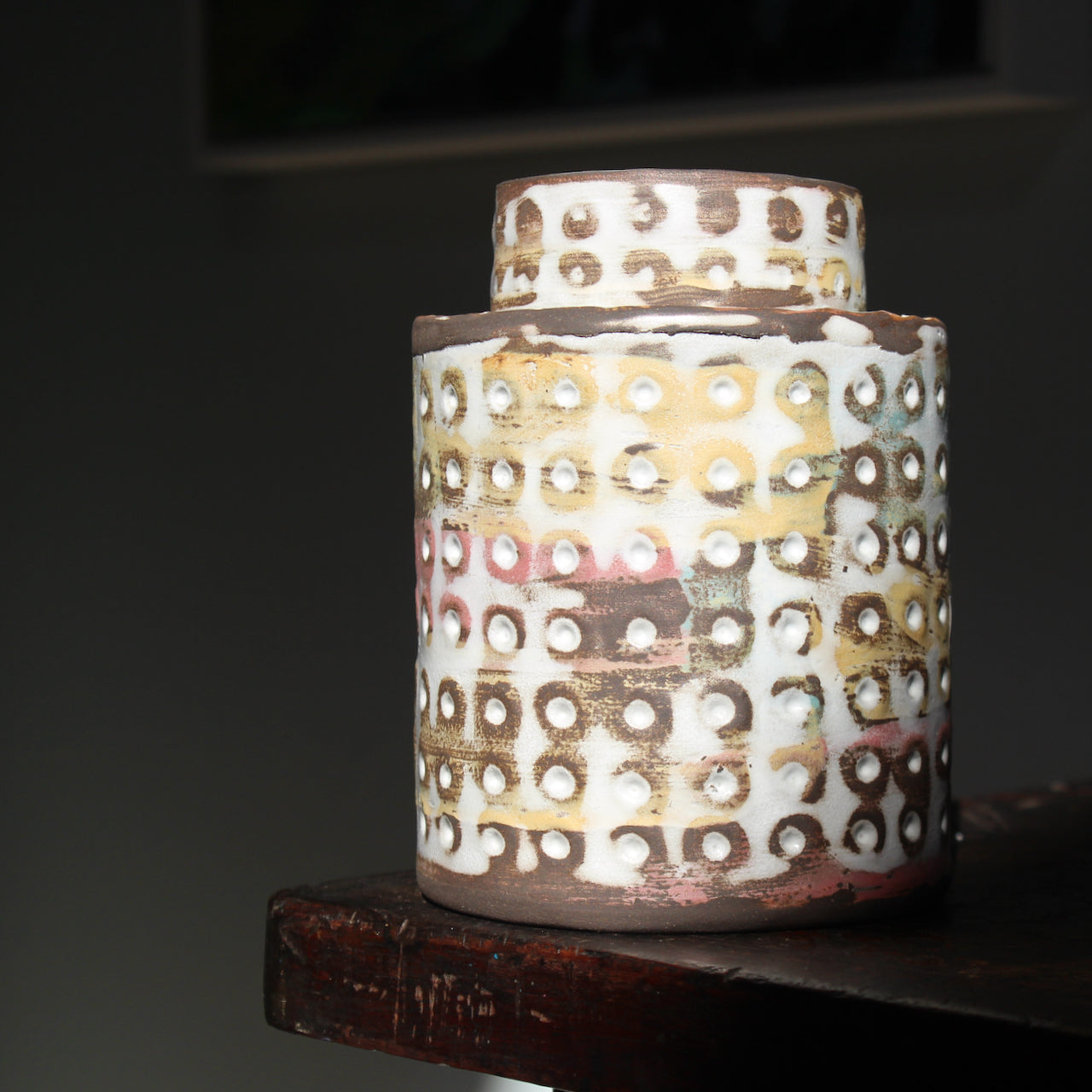 textured ceramic vessel in pinks, blues and mustard by UK ceramicist Elly Wall