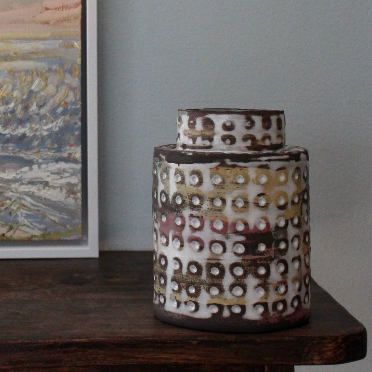  textured ceramic vessel in pinks, blues and mustard by UK potter Elly Wall