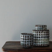 two  textured ceramic vessels in brown, blues and green by UK ceramicist Elly Wall
