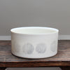 white porcelain serving dish decorated with abstract black circles 
