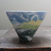 small ceramic bowl in blue, yellow and green by  Judy Mckenzie, ceramicist.