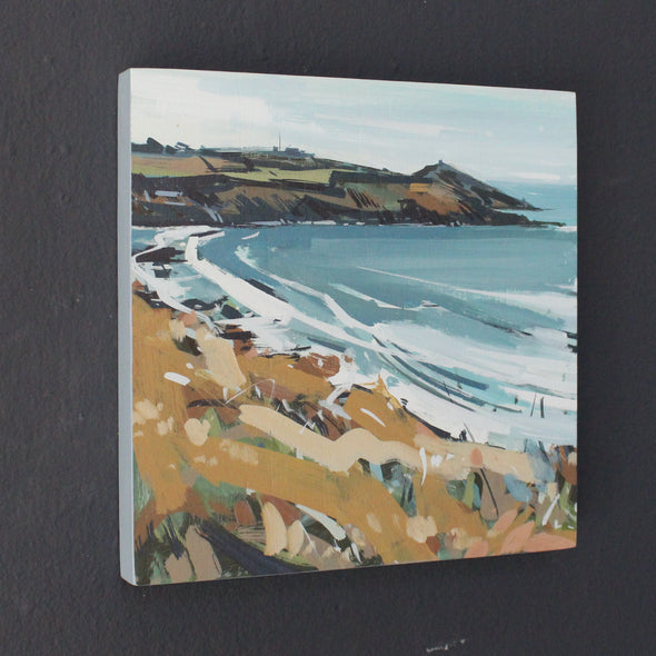 an Imogen Bone landscape painting of Rame Head, a peninsula in south east Cornwall, painted in autumn with a blue sea, pale sky and brown and green grasses.