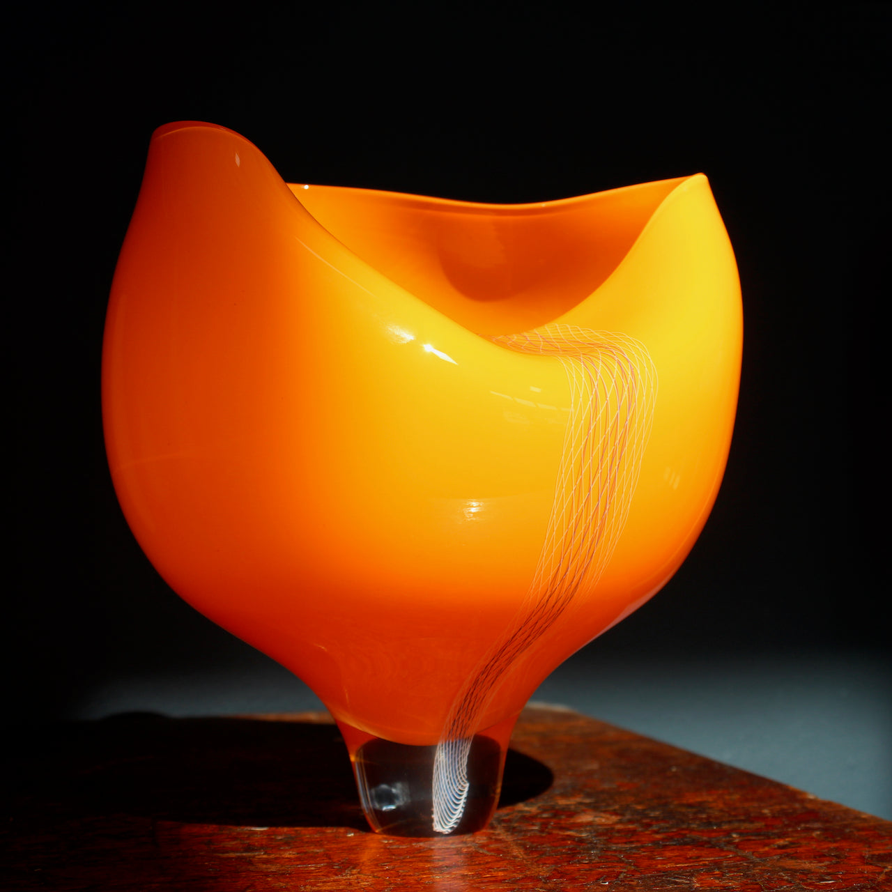 orange coloured glass vessel with line detail to the front made by UK glass artist Benjamin Lintell