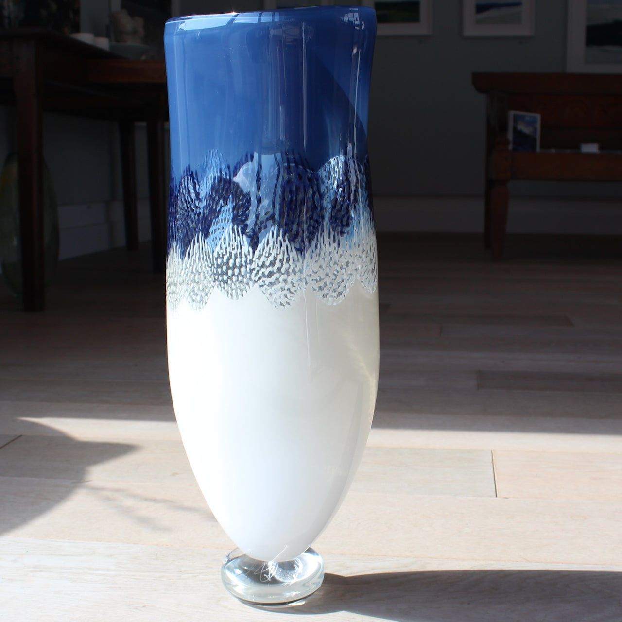 Tall blue and white glass vessel by glass artist Benjamin Lintell