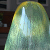 Close up of glass vessel in green and yellow by glass artist Benjamin Lintell