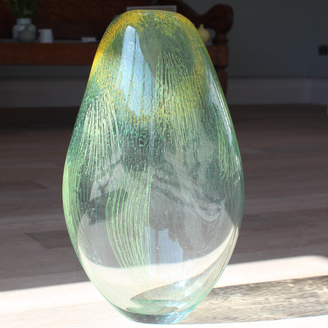 green and yellow glass vessel by glass artist Benjamin Lintell at the Byre Gallery