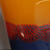 close up detail of glass vessel by Benjamin Lintell with a blue base and orange top divided by a red detail.
