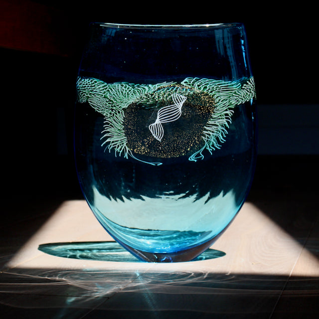blue glass vessel with centre detail by Benjamin Lintell  photographed in sunlight