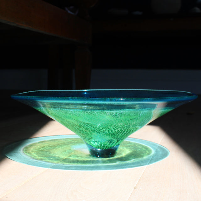 reflection of blue and green glass bowl by Benjamin Lintell  photographed in sunlight