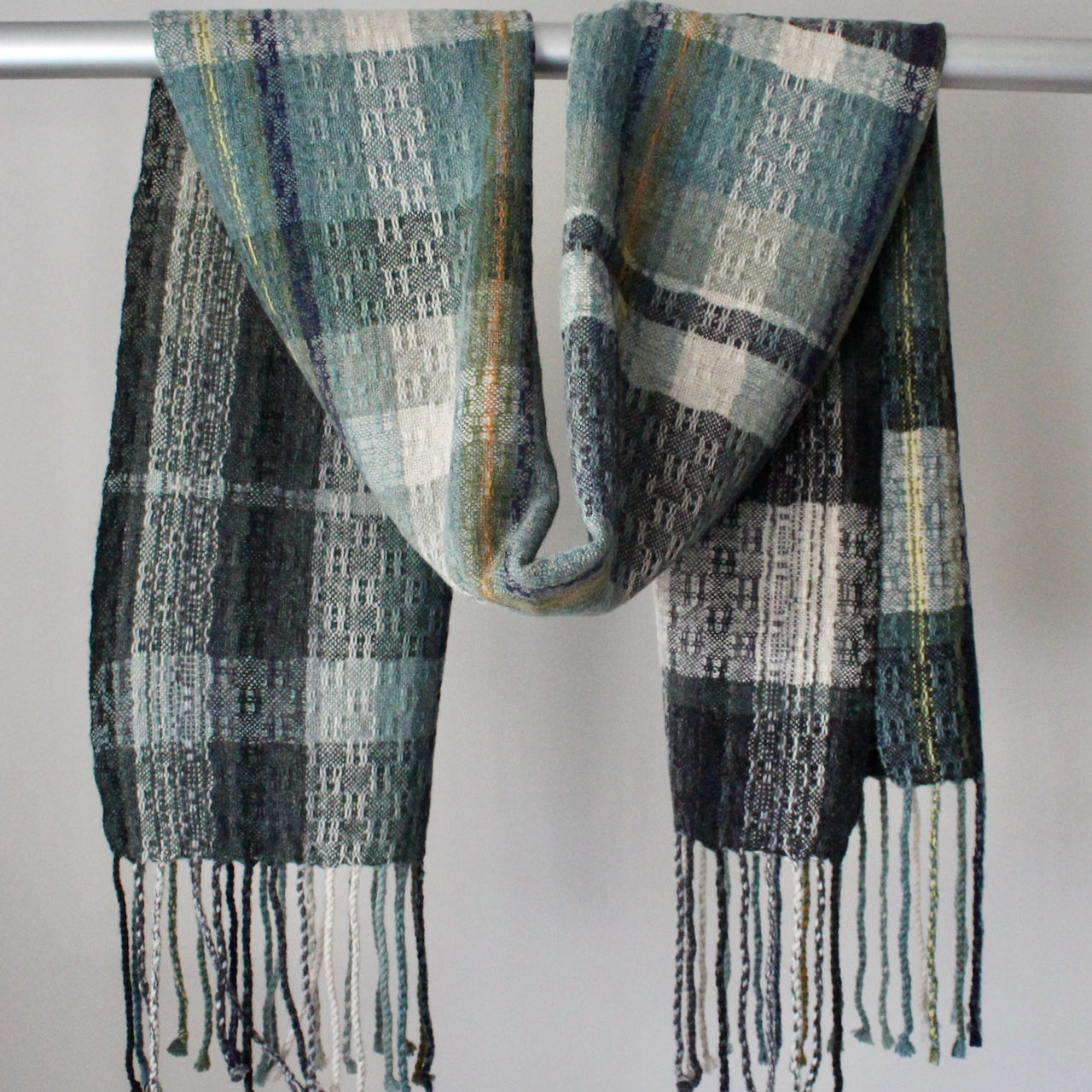Cornish textile designer Teresa Dunne's handwoven scarf in blues, greens and greys.