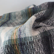 textile designer Teresa Dunne's handwoven scarf in blues, greens , orange and greys