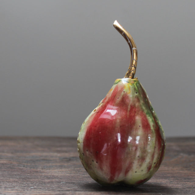 ceramic red and green pear and a gold stalk by Remon Jephcott