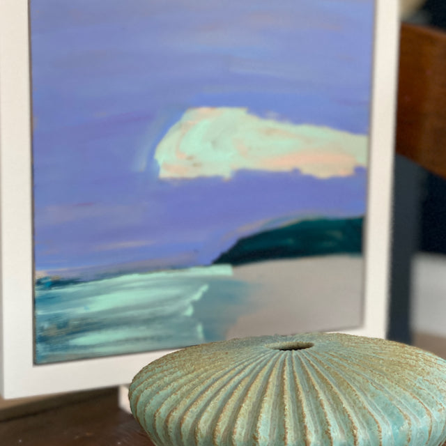 an abstract seascape painting in purples and greens by Cornwall artist Alex Yarlett palmed next to a flat ceramic bowl by Michele Bianco