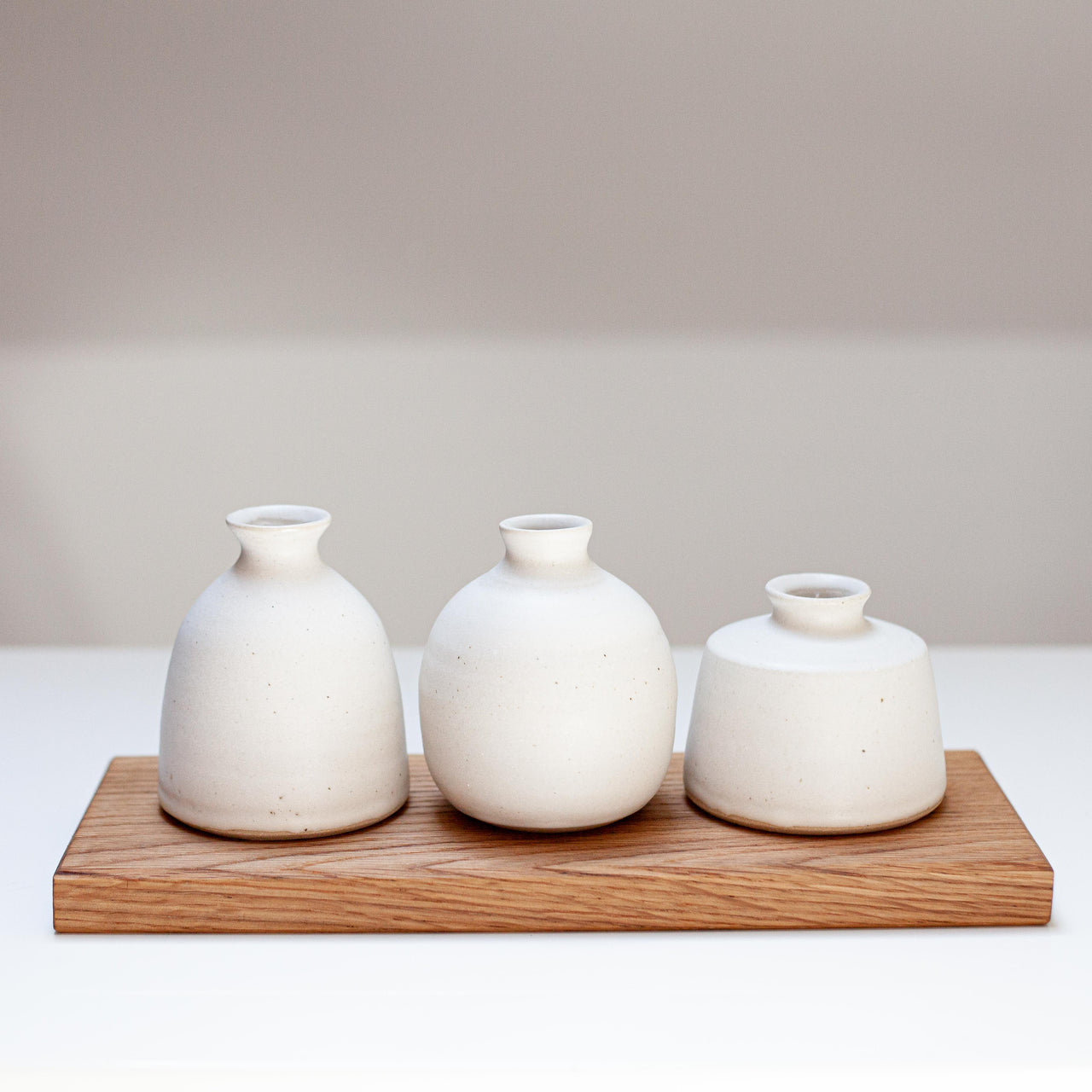 Bud vase grouping on oak boards by Emily Olivia Tapp