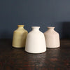 white, yellow and pale pink bud vases by EOT ceramics 