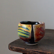 a ceramic teabowl in red and yellow by leading UK potter John Pollex.