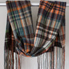 A Handwoven scarf with orange, brown and blue colours hanging over a display rail 