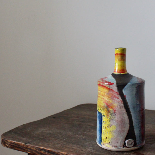 a red, yellow and blue ceramic bottle by UK potter John Pollex.