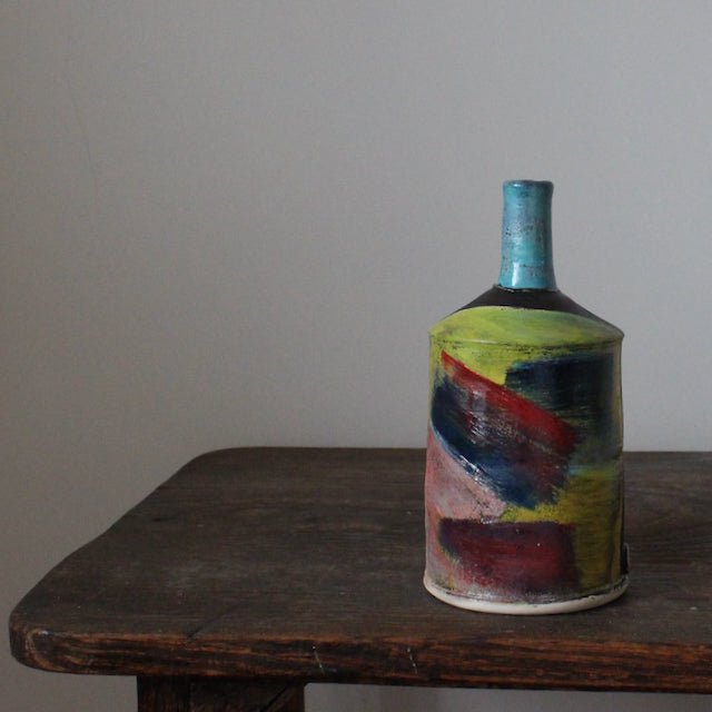 multi-coloured ceramic bottle with a blue neck by potter John Pollex 