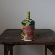 a brightly coloured ceramic bottle by UK potter John Pollex.