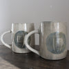 a pair of ceramic mugs by Kate Welton.