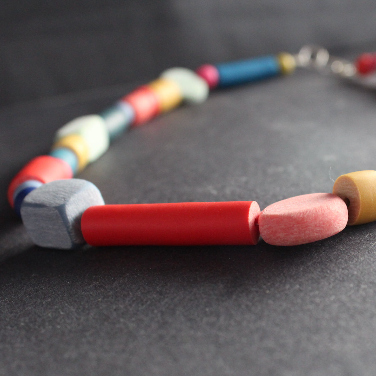 close up of part of a multi coloured random shaped bead necklace by Clare Lloyd, jewellery designer