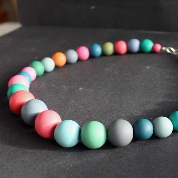close up of part of a multi coloured bead necklace by jewellery designer Clare Lloyd