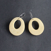 pair of oval shaped pale yellow earrings with hole in the middle  by UK jewellery designer Clare Lloyd