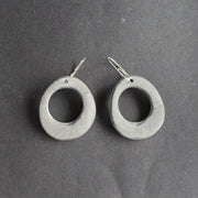 oval shaped pale grey earrings with hole in the middle  by UK jewellery designer Clare Lloyd 