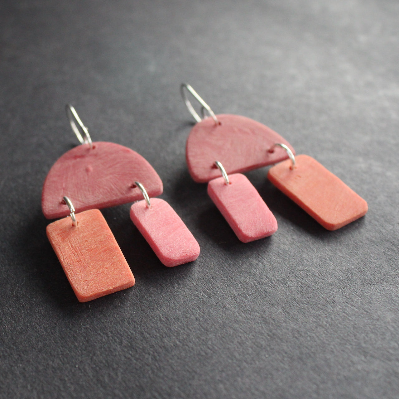 a pair of red and pink earrings by jewellery designer Clare Lloyd