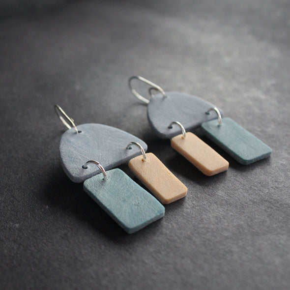 pair of earrings in blue, turquoise and pale yellow by jewellery designer Clare Lloyd.