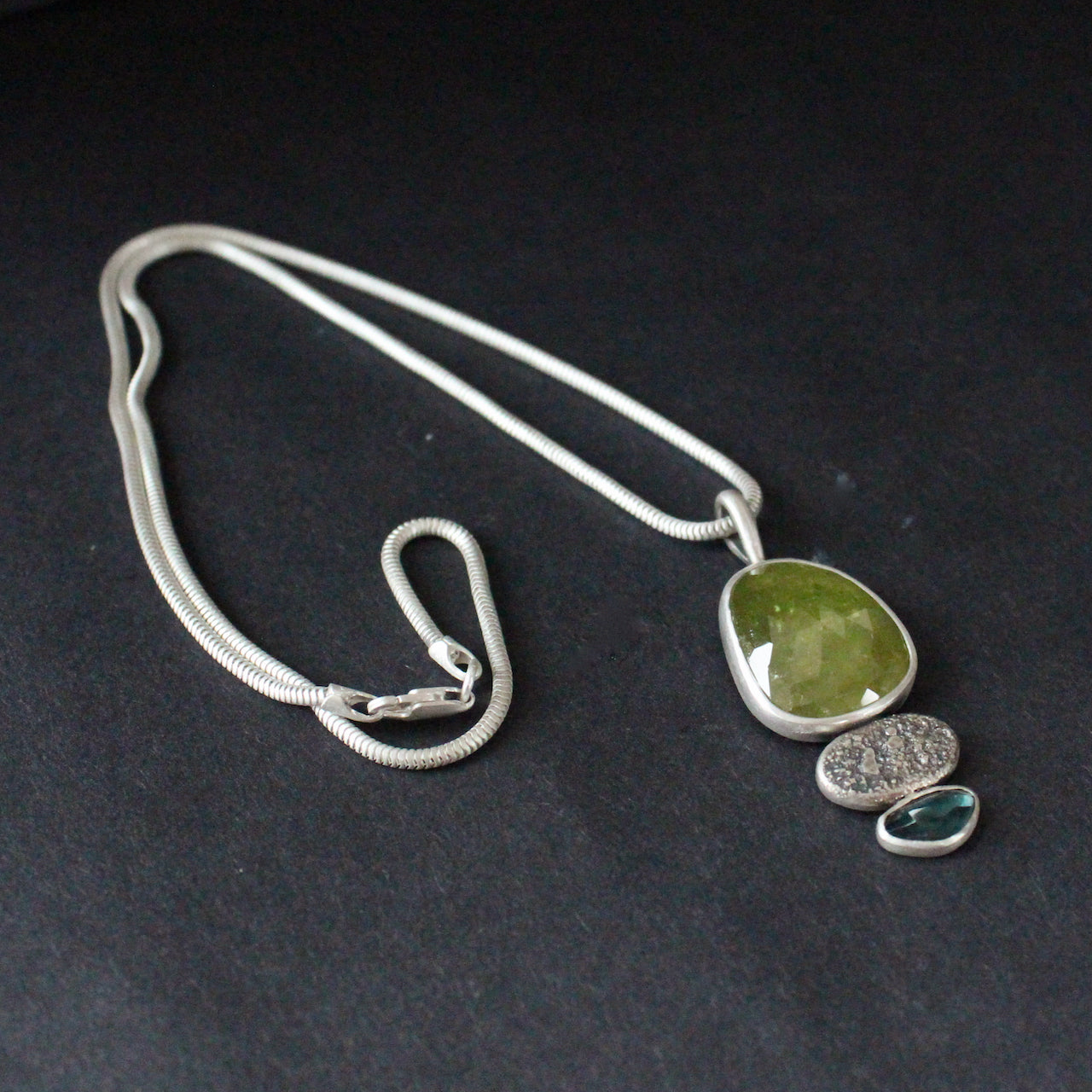 Sphene and blue tourmaline textured silver duo pendants on silver chain by Carin Lindberg