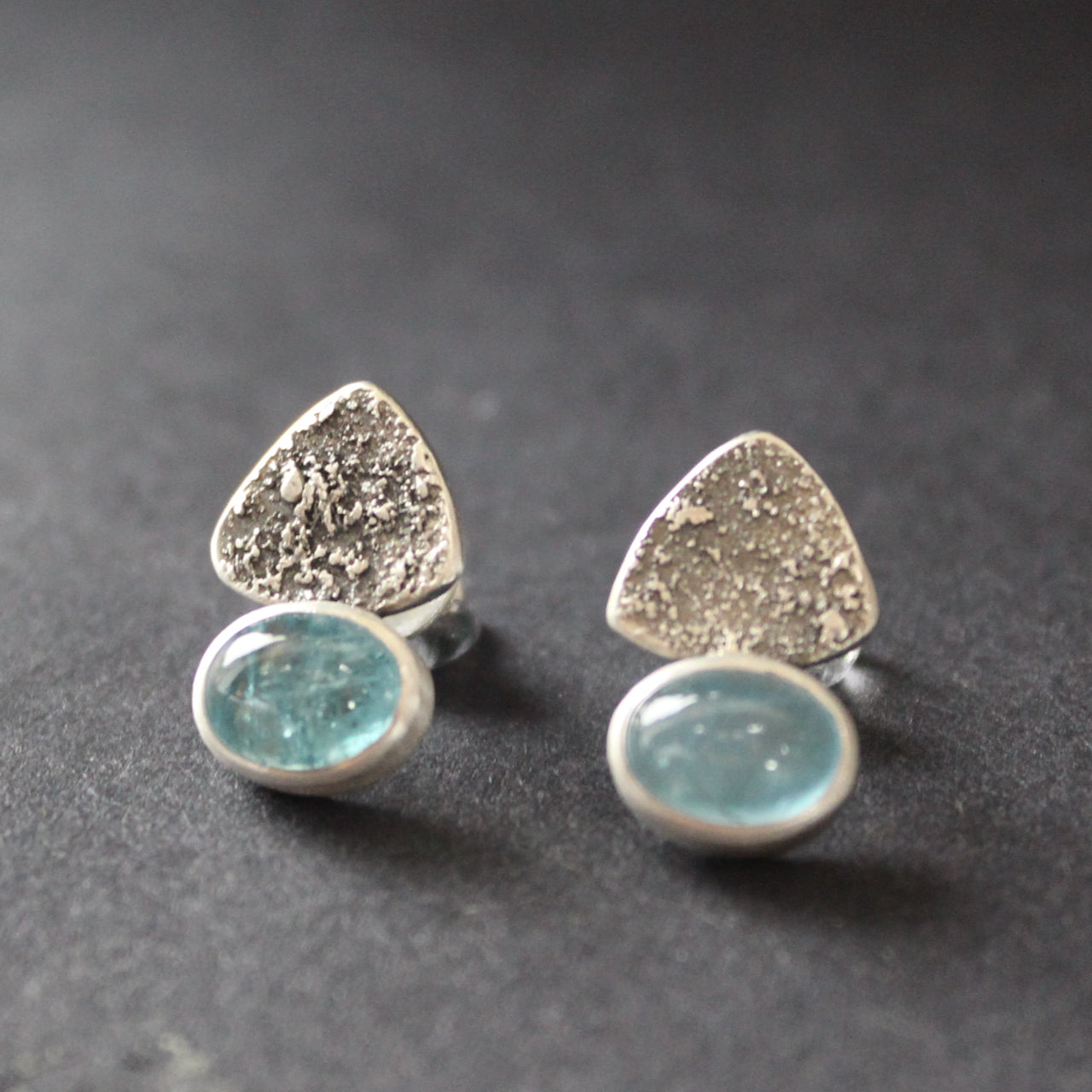 a pair of textured silver earrings with blue stone by jeweller Carin Lindberg