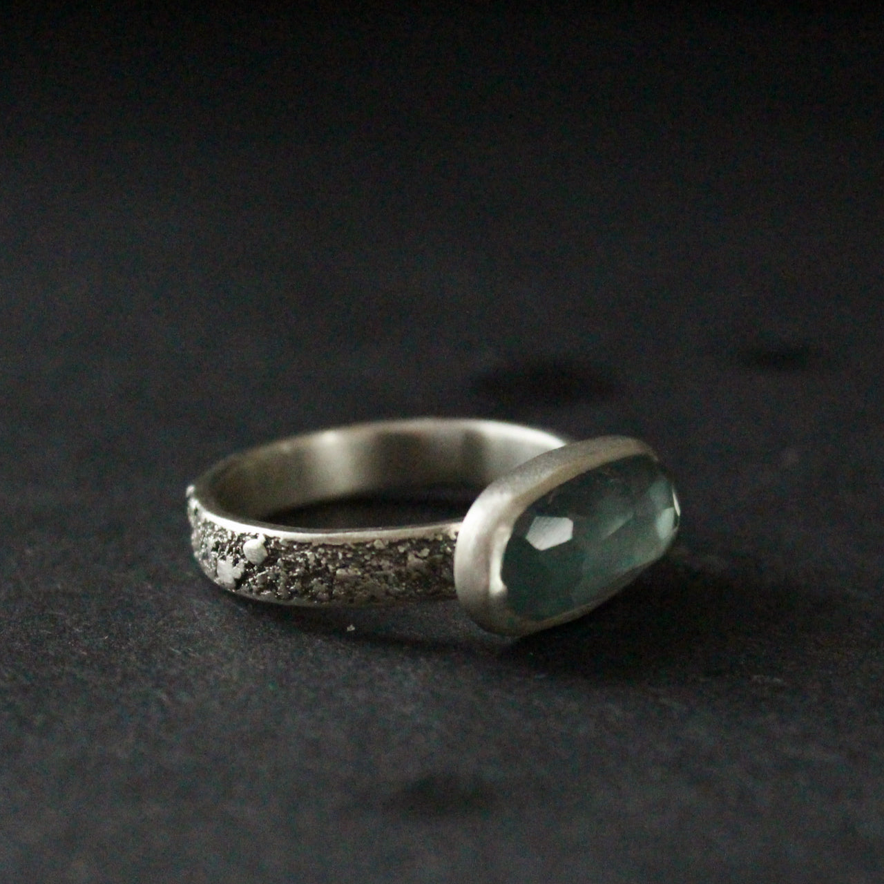 a textured silver ring with a long blue stone by jeweller Carin Lindberg.