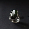 three banded silver ring with a dark green stone by jeweller Carin Lindberg.