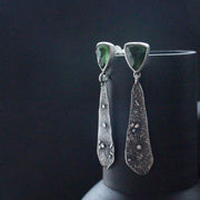 textured silver earrings with a dark green stone by Cornwall  jeweller Carin Lindberg.
