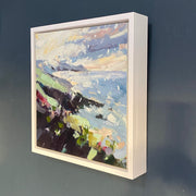 a Jill Hudson painting of Rame Head coastline in Cornwall in a wintery scene with a flurry of snowflakes.