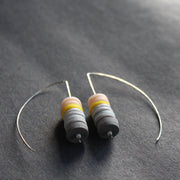 earrings made of small discs on top of each other in shades of grey and pink by jewellery designer Clare Lloyd 