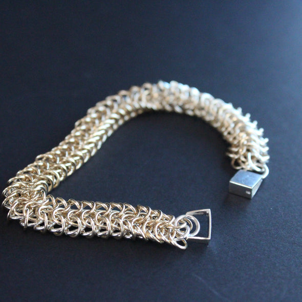 chainmail tube  bracelet in gold and silver  made by UK jeweller Corrinne Eira Evans 